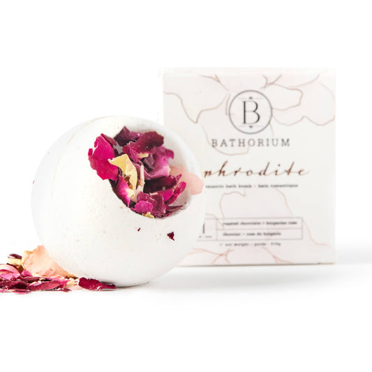 Exquisite bath bomb with rose petals and a box, infusing the water with vanilla, chocolate, and rose fragrances.