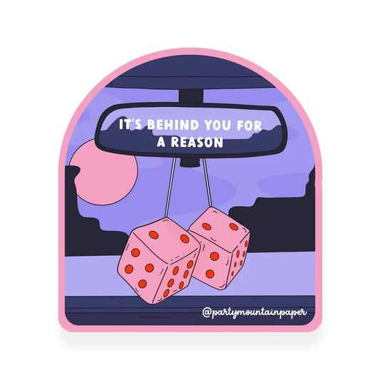A waterproof sticker with the phrase "It's behind you for a reason" written on it with a dice hanging from rearview mirror illusatrated design.