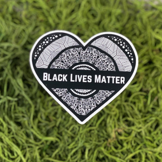 A heart-shaped sticker with "Black Lives Matter" written on it. Waterproof, dishwasher-safe, and weatherproof for long-lasting support.